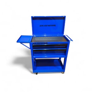 May include: A bright blue rolling tool chest with the lid open, revealing a black interior. The chest has three drawers with black handles and a side tray. The text "US GENERAL" is visible on the lid and the front of the chest.