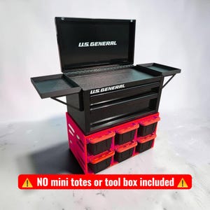 May include: A black U.S. General tool box with an open lid and two side trays, resting on a bright neon pink storage rack containing six small black bins with orange lids. Text on the image reads: NO mini totes or tool box included.