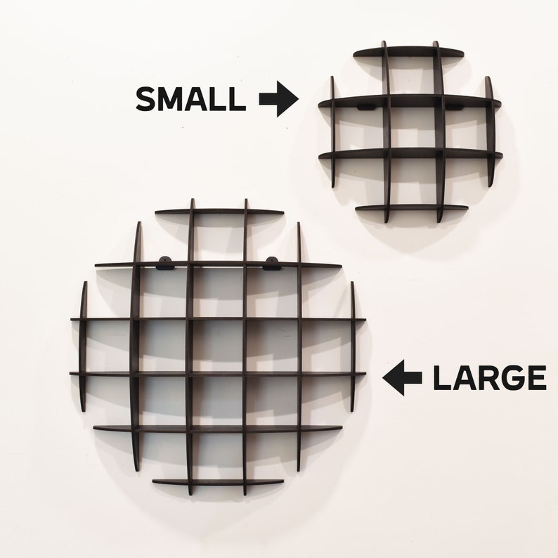 May include: Two black circular wall shelves with a grid pattern. The smaller shelf is labelled "SMALL" and the larger shelf is labelled "LARGE".
