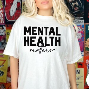 a woman wearing a white shirt with the words mental health matters printed on it