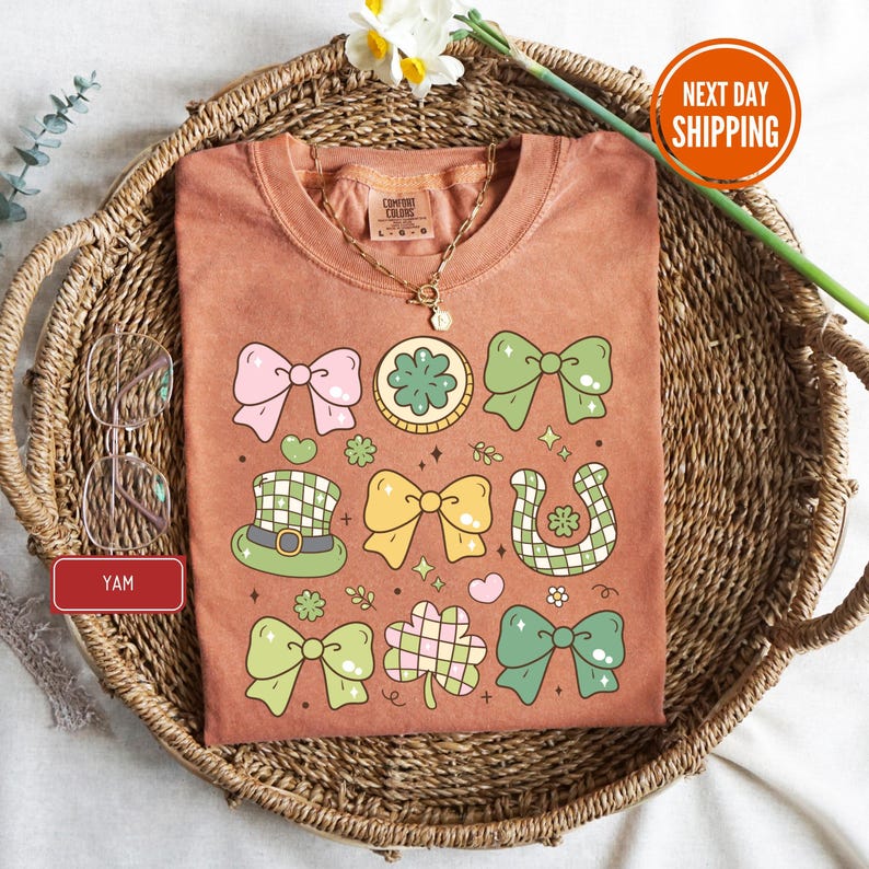 a t - shirt with a bow tie on it sitting on a wicker basket