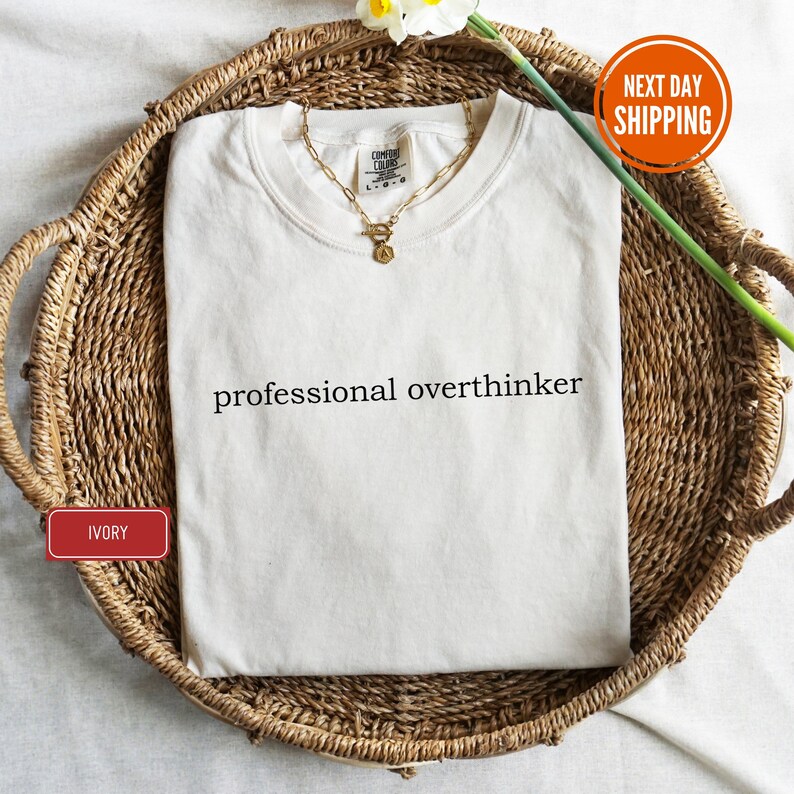a white shirt that says professional overthiker on it