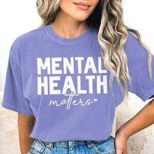 a woman wearing a purple shirt that says mental health matters