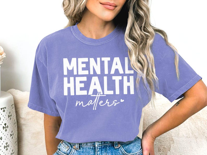 a woman wearing a purple shirt that says mental health matters