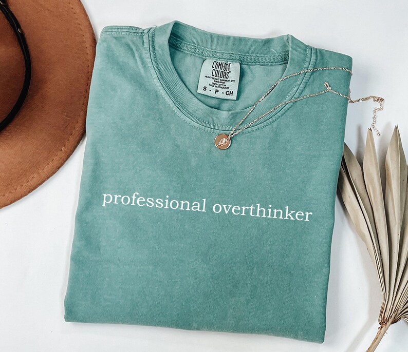a t - shirt that says professional overthiker on it