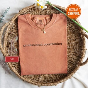 a t - shirt that says professional overthiker on it