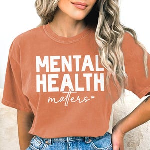 a woman wearing a t - shirt that says mental health matters