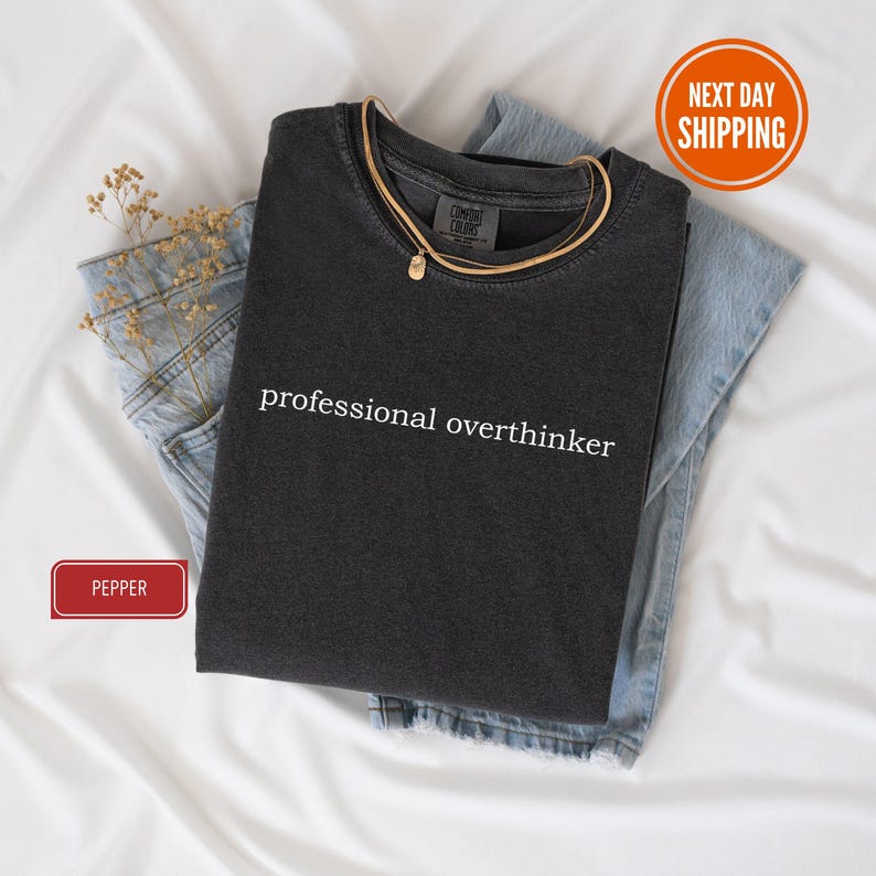 a black shirt that says professional overthiker on it