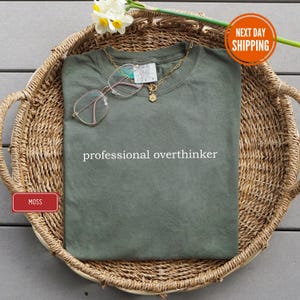 a shirt that says professional overthinker on it
