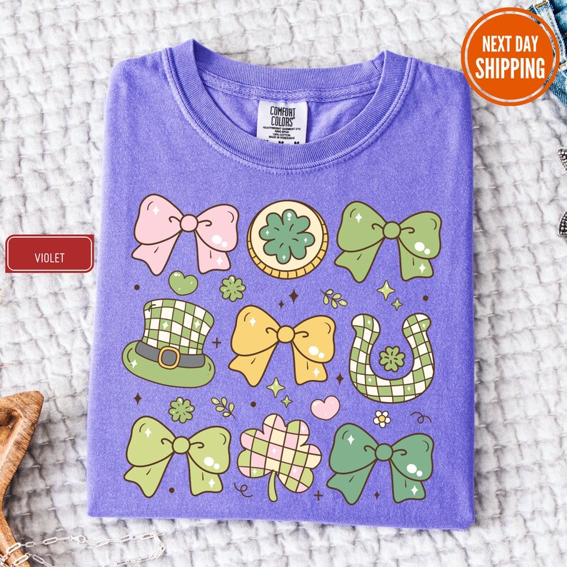 a purple t - shirt with green and pink bows on it