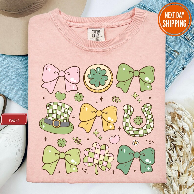 a pink tshirt with bows and shamrocks on it