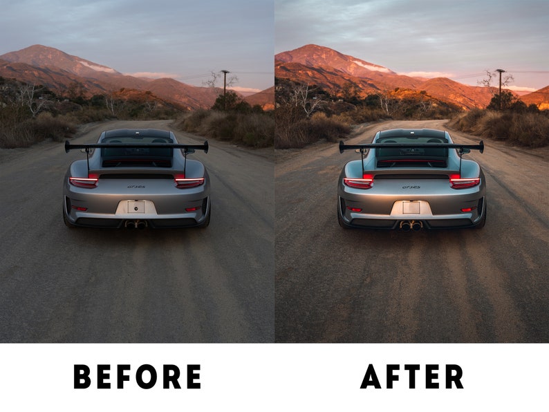 May include: A silver Porsche 911 GT3 RS with a black rear wing and red tail lights is parked on a paved road. The car is facing away from the camera. The background is a mountain range with a sunset sky.