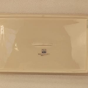 May include: Off-white rectangular ceramic serving tray with handles. The tray has a slightly raised edge and a smooth surface. The base of the tray has the text "Blue Sky" and "Microwave and Dishwasher Safe".