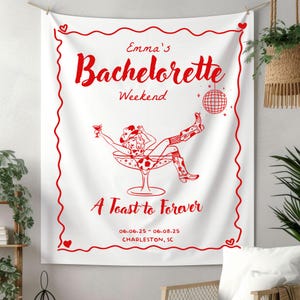May include: Red and white bachelorette party tapestry with a cowgirl in a martini glass, text reads "Emma's Bachelorette Weekend, A Toast to Forever, 06.06.25 - 06.08.25, CHARLESTON, SC"