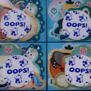 May include: Four sheets of colorful stickers with cartoon characters and the word "OOPS!" repeated on each sheet. The stickers are on a blue background.