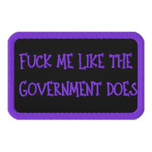 May include: Rectangular patch with a black background and a purple border. The patch features the embroidered text "FUCK ME LIKE THE GOVERNMENT DOES" in purple thread.