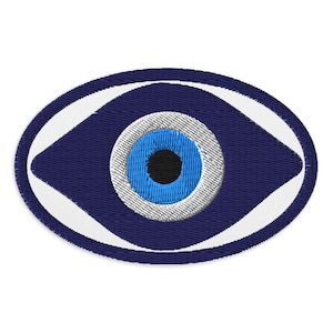 May include: Embroidered patch featuring a blue eye design. The eye has a blue iris with a black pupil, surrounded by a white and gray ring. The patch is oval-shaped with a dark blue background and white border.