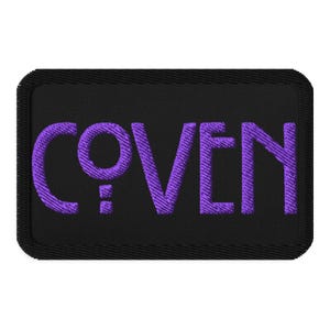 May include: Black rectangular patch with the word "COVEN" embroidered in purple thread. The patch has rounded corners and a black border. The letters are in a bold, stylized font.