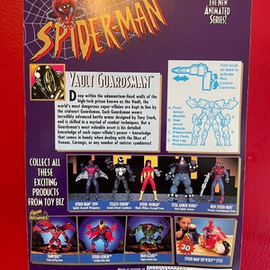May include: A red, white, and blue action figure of Spider-Man in a silver and black suit. The figure is holding a weapon and is standing on a black base. The figure is part of a collection of Spider-Man action figures. The back of the packaging features a description of the figure and other figures in the collection. The packaging also includes a "Proof of Purchase" sticker.
