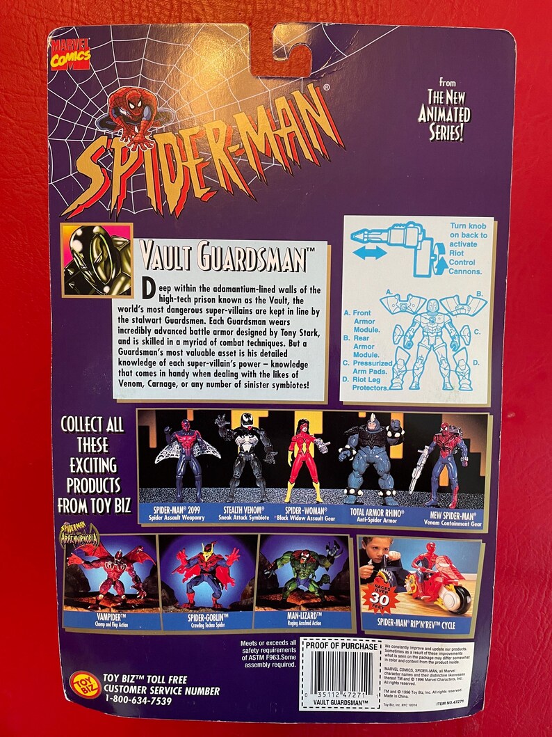 May include: A red, white, and blue action figure of Spider-Man in a silver and black suit. The figure is holding a weapon and is standing on a black base. The figure is part of a collection of Spider-Man action figures. The back of the packaging features a description of the figure and other figures in the collection. The packaging also includes a "Proof of Purchase" sticker.