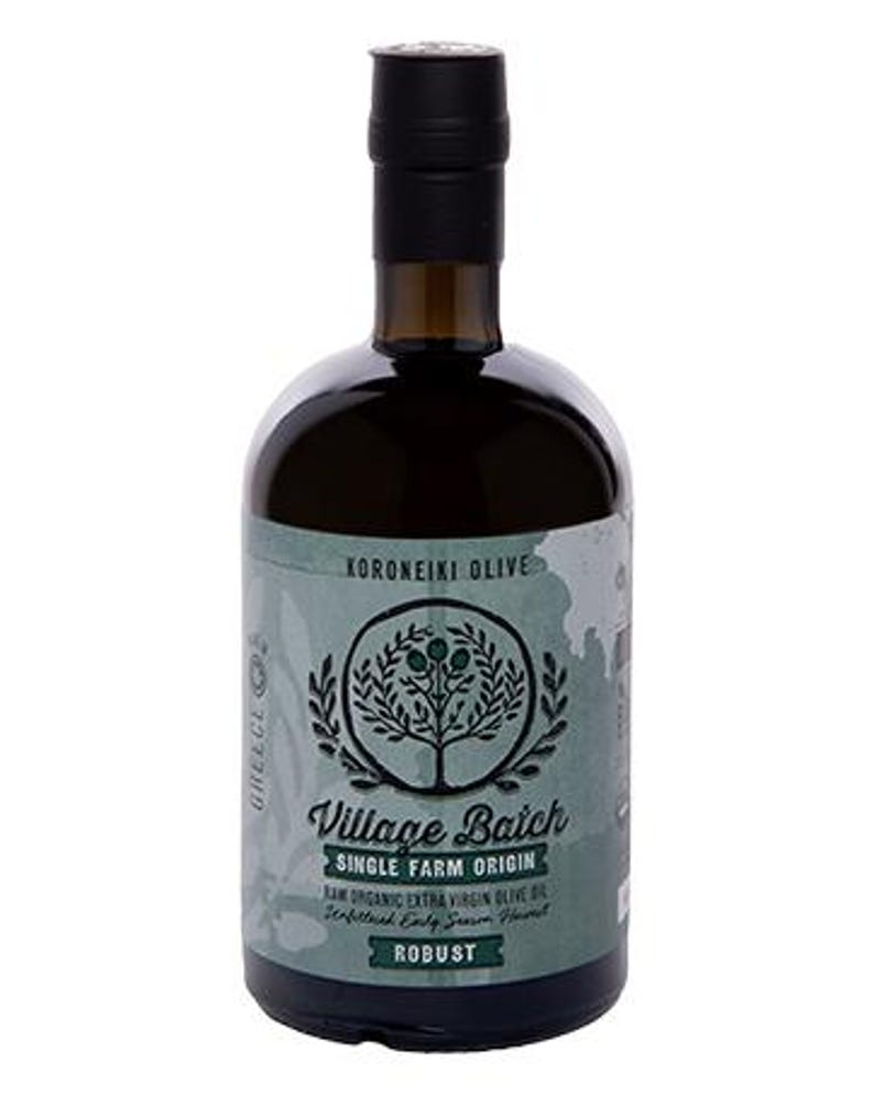 May include: A dark glass bottle of olive oil with a black cap. The label features a green background with a tree illustration, the text Village Batch, Single Farm Origin, Koroneiki Olive, and Robust, indicating raw organic extra virgin olive oil.