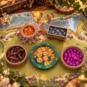 May include: A board game set featuring a tree stump bowl with orange crystals, a wooden cart with grey pebbles, a brown barrel with brown logs, a green circular tray with yellow number tokens, and a brown bowl with purple berries.