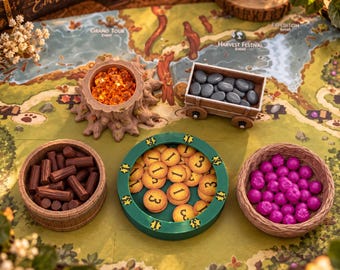 May include: A board game set featuring a tree stump bowl with orange crystals, a wooden cart with grey pebbles, a brown barrel with brown logs, a green circular tray with yellow number tokens, and a brown bowl with purple berries.