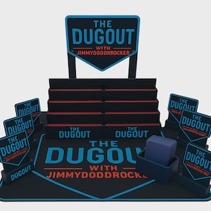 May include: A black and blue display stand with the text "THE DUGOUT" and "WITH JIMMYDODDRROCKER". The display has multiple levels and several smaller signs with the same text. A blue container holds a stack of blue cards.