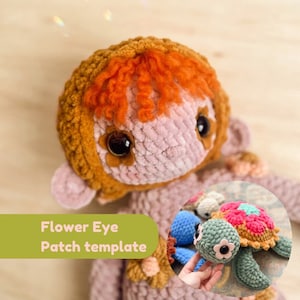 May include: A crocheted doll with brown and pink yarn, orange hair, and large brown eyes. The doll is holding a crocheted turtle with a pink and green shell and a flower design. The text "Flower Eye Patch template" is visible in the image.