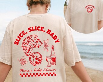 May include: Ivory t-shirt with a red graphic of pizza slices, wine, and cutlery. The text "Slice, Slice, Baby" is in a red circle around the pizza slices. The text "Olivia's Baby Shower" is below the graphic.