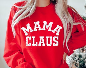 Op de afbeelding: Rood sweatshirt met witte tekst die "Mama Claus" zegt.