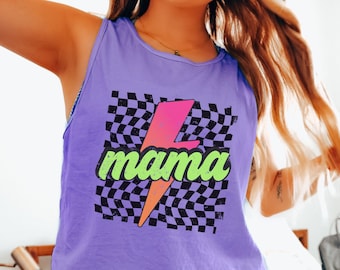 May include: Purple tank top with a black and white checkered pattern and a pink lightning bolt with the word "mama" in green letters.