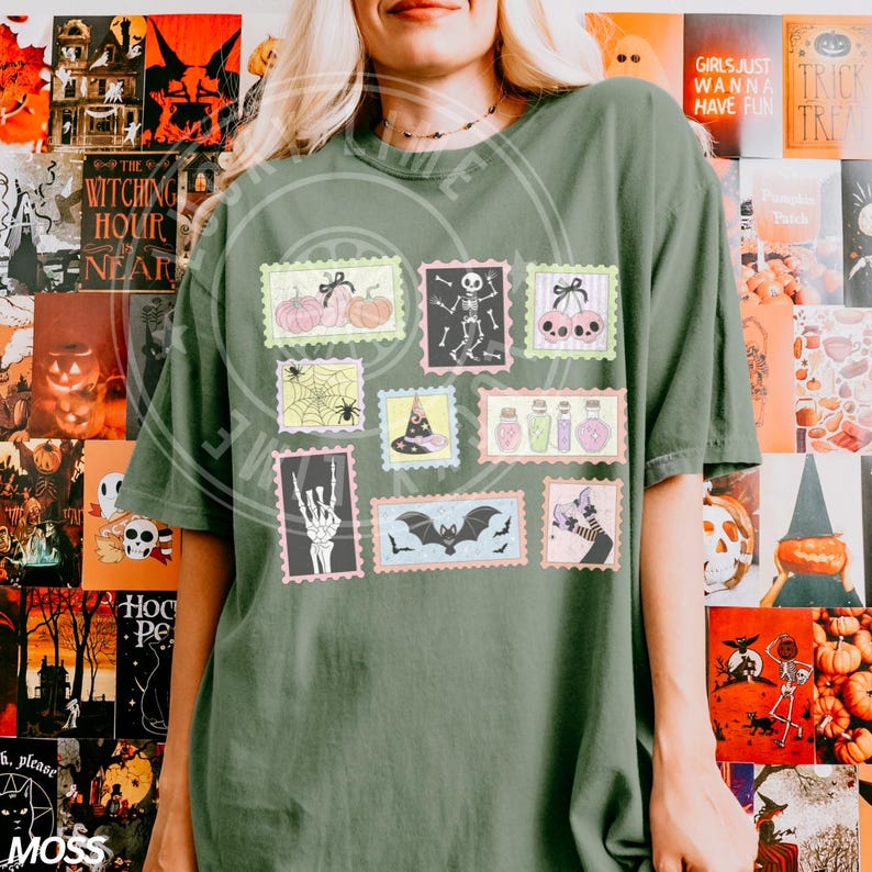 May include: Olive green t-shirt featuring a collection of Halloween-themed postage stamp designs. The stamps showcase pumpkins, skeletons, spiders, witch hats, potions, bats, and cats. The shirt has the word "MOSS" at the bottom.