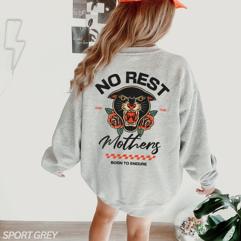 May include: A gray sweatshirt with a black panther graphic and the text "No Rest for the Mothers Born to Endure".