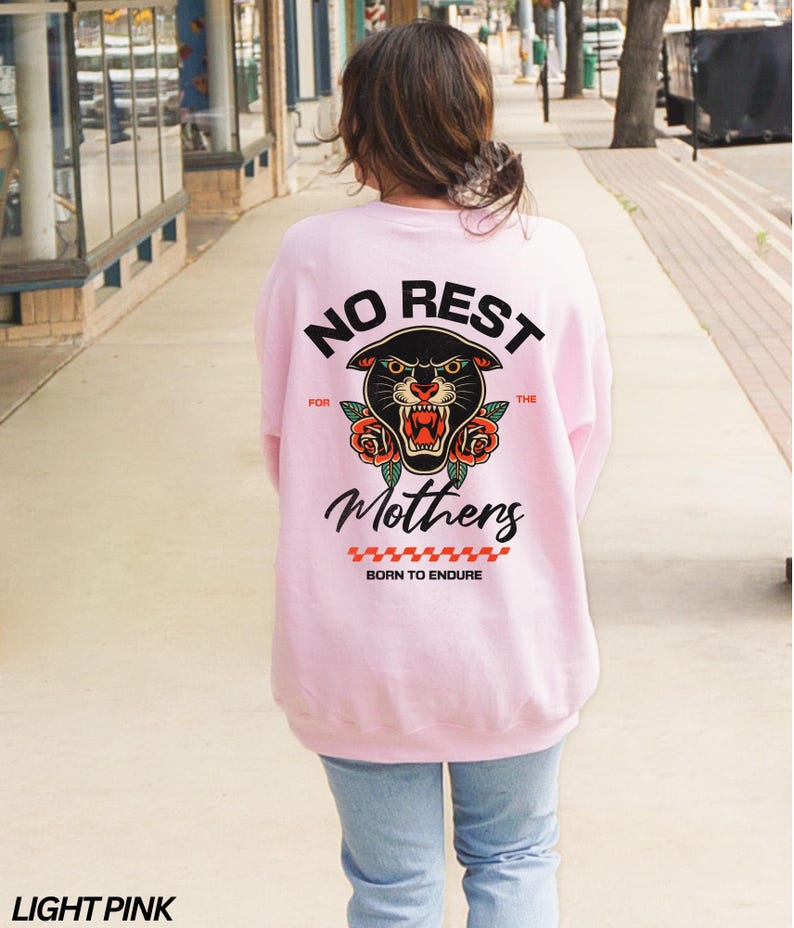 May include: A light pink sweatshirt with a black panther graphic and the text "NO REST FOR THE MOTHERS BORN TO ENDURE".