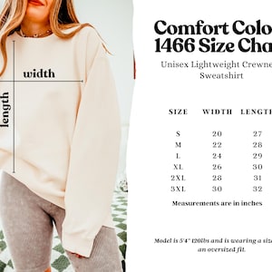 May include: Size chart for a unisex lightweight crewneck sweatshirt in sizes S-3XL. The chart shows the width and length measurements in inches. The model is wearing a size L.