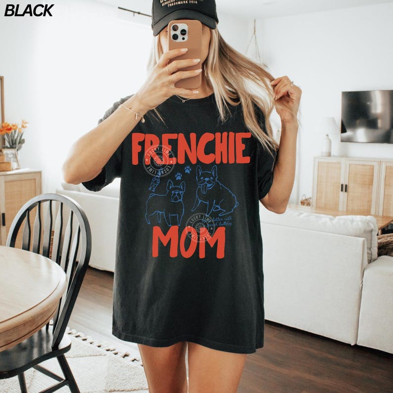 May include: Black t-shirt with the words "FRENCHIE MOM" in red, and two blue French Bulldog illustrations. The shirt also features a circular design with text and paw prints.