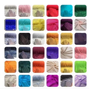 Puede incluir: Surtido de 36 rollos de tela transparente en varios colores, incluyendo azul, verde, rojo, amarillo, naranja, rosa, morado y blanco. La tela est&aacute; enrollada y se muestra sobre un fondo blanco.