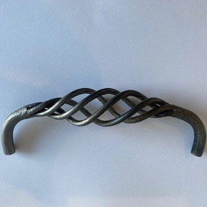 May include: A dark grey metal cabinet pull with a woven, intertwined design. The handle has a curved shape with a textured finish, suitable for furniture or cabinetry. The overall design is rustic and elegant.