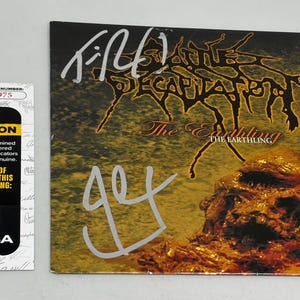 May include: A signed album cover for the band 'Fleshgrind's' album 'The Earthling'. The cover is dark with a grotesque image and the band's name in a spiky font. A JSA certification sticker is on the left.