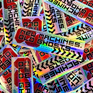 May include: A collection of holographic stickers with a vibrant, iridescent finish. The stickers feature bold text in black and red, including phrases like "NEW OLD MACHINES" and "ALWAYS HAUNTED, ALWAYS RUNNING, NEVER SILENT."