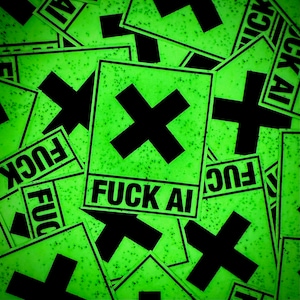 May include: A collection of neon green stickers with a black cross and the words "FUCK AI" printed in black. The stickers have a speckled texture and are scattered across the image.
