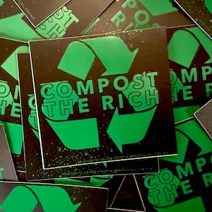 May include: Square stickers with a black background and green text and graphics. The text reads "COMPOST THE RICH" with a recycling symbol. The stickers are scattered, with some partially visible.