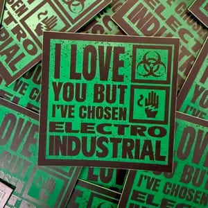 May include: Square sticker with a green background and black text that reads "I LOVE YOU BUT I'VE CHOSEN ELECTRO INDUSTRIAL." The sticker also features biohazard and hand symbols. Other stickers with similar designs are in the background.