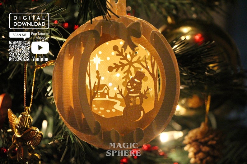 May include: A white paper Christmas ornament with a cut-out design of a winter scene. The scene includes a snowman, a house, a tree, and a star. The ornament is illuminated from within, creating a warm glow.