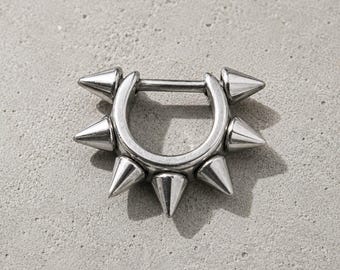 May include: A silver-toned circular hoop earring featuring six evenly spaced, pointed conical spikes protruding outwards from the outer edge. The piece has a hinged closure mechanism with a straight bar that spans the opening of the hoop.