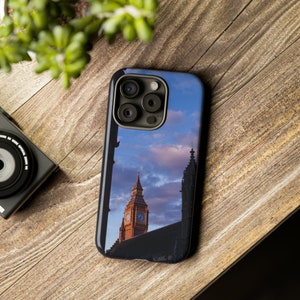 Peut inclure: Une coque de téléphone noire avec une photo du Big Ben à Londres, en Angleterre. La photo montre la tour de l'horloge avec un ciel bleu et des nuages en arrière-plan.