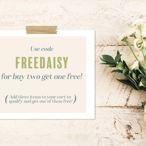 May include: A white card with brown tape at the top, with the text "Use code FREEDAISY for buy two get one free! (Add three items to your cart to qualify and get one of them free!)"
