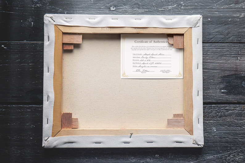 May include: The back of a stretched canvas painting with a Certificate of Authenticity attached. The certificate is for a "Short Beach Scene" painting by "Sandy Stern" and is dated 12/20/2021.
