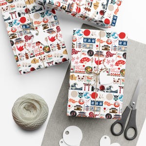 May include: White wrapping paper with a repeating pattern of Japanese cultural icons, including red lanterns, cherry blossoms, koi fish, and a red sun. The text "居酒屋" is repeated throughout the pattern.